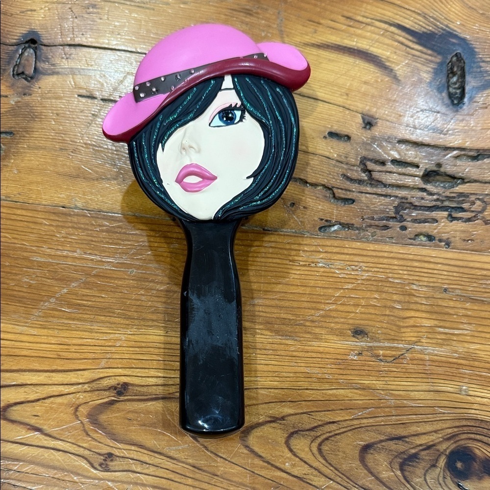 Black Hairbrush with woman face and hat painted on.